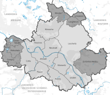 Černobílá grafika s mapou města s vyznačenými barevně rozlišenými částmi